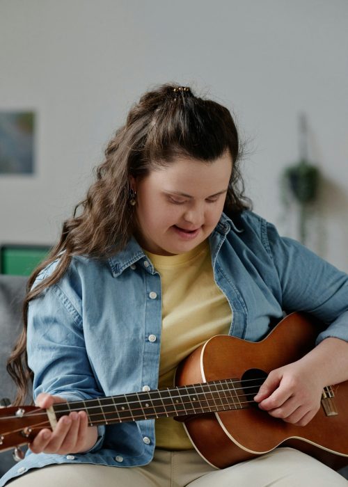 Girl with down syndrome learning to play guitar